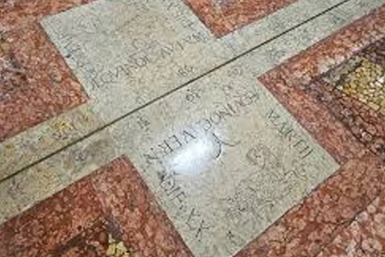 Close-up of historic meridian line engraving on marble floor inside Basilica of San Petronio Bologna