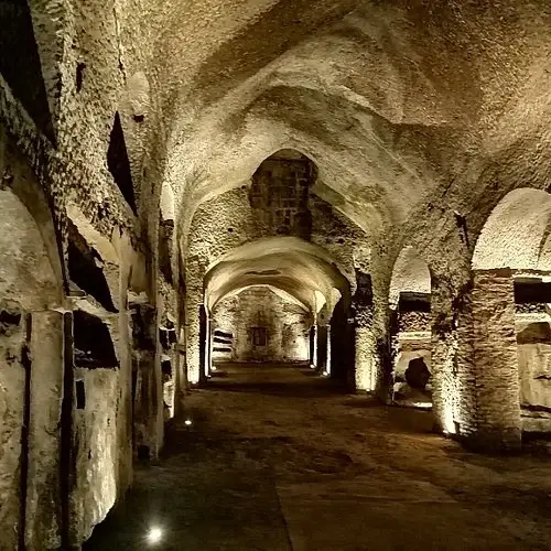 Stone corridor inside Naples underground catacombs